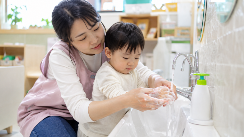 Korean-daycare-teacher-toddler-handwashing-with-soap-and-running-water